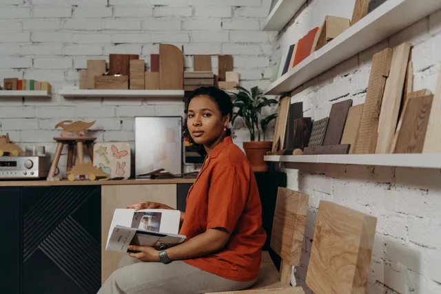 Woman in showroom browsing wooden samples for interior design projects. Costruire un catalogo prodotti efficace per lo shopping online in Svizzera